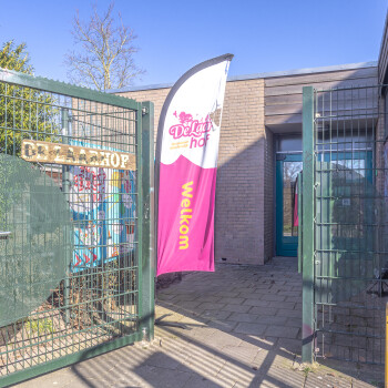 entree met toegangshek en welkomsvlag